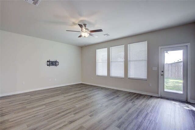 empty room with ceiling fan and light wood-type flooring