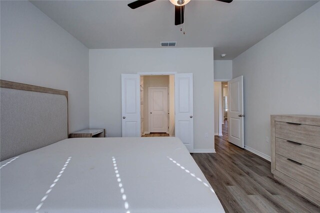 unfurnished bedroom featuring hardwood / wood-style floors and ceiling fan