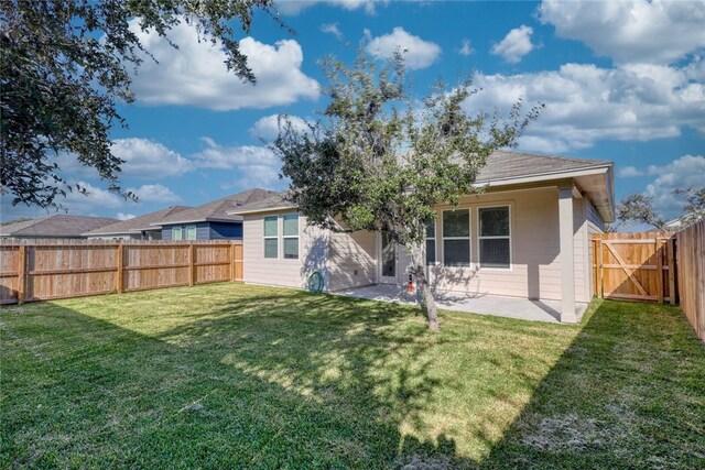 back of house featuring a yard and a patio