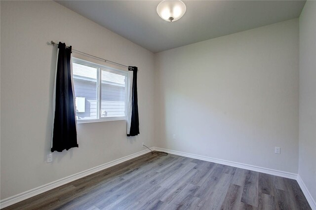 spare room with hardwood / wood-style flooring