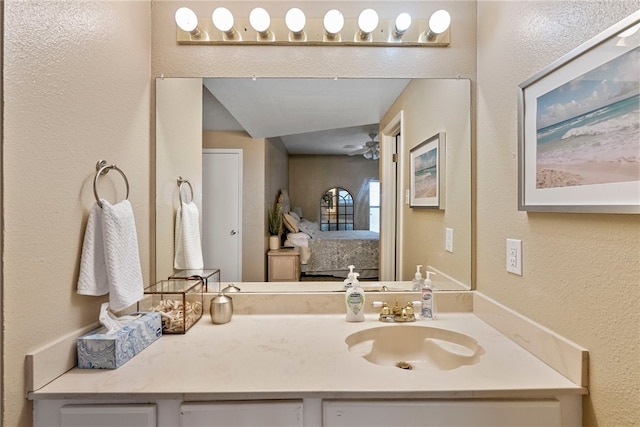 bathroom with ceiling fan and vanity