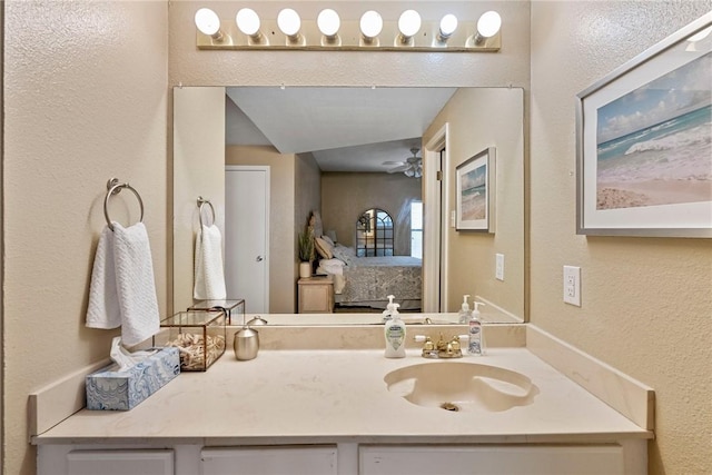 6317 State Highway 361 Unit 6203, Port Aransas, TX 78373 - ensuite bathroom featuring a textured wall, vanity, and a ceiling fan