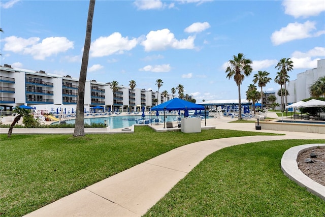 view of community with a swimming pool and a yard