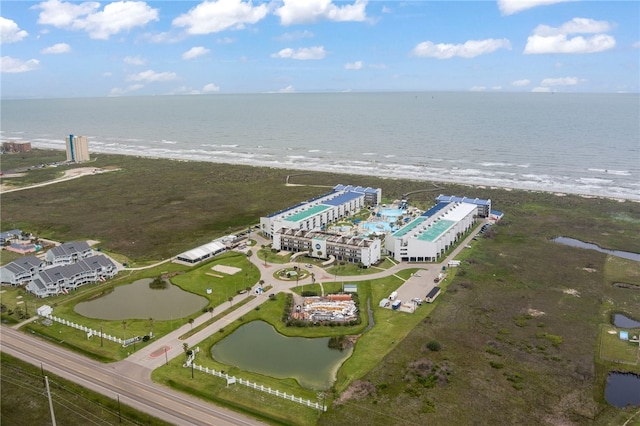 birds eye view of property featuring a water view and a view of the beach