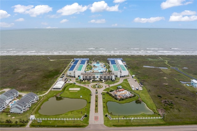 drone / aerial view featuring a beach view and a water view