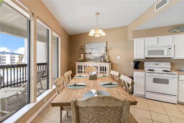 dining room featuring a chandelier and light tile patterned floors