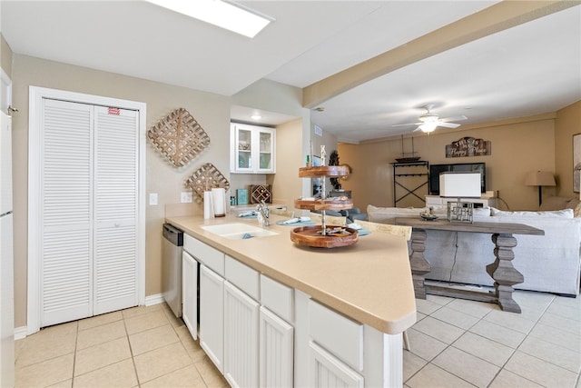 kitchen with dishwasher, white cabinetry, sink, and kitchen peninsula