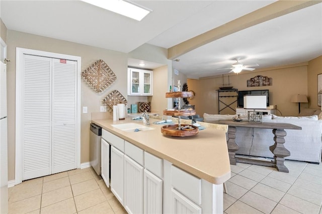 6317 State Highway 361 Unit 6203, Port Aransas, TX 78373 - kitchen featuring a peninsula, light tile patterned flooring, dishwasher, white cabinets, and a ceiling fan