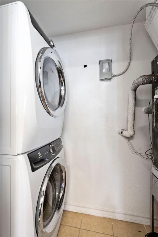 6317 State Highway 361 Unit 6203, Port Aransas, TX 78373 - washroom featuring stacked washer / dryer and light tile patterned floors