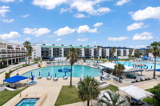 view of swimming pool with a community hot tub and a patio