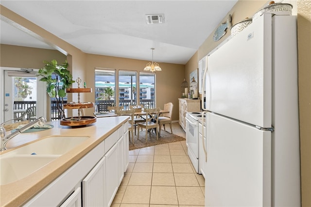 kitchen with white cabinetry, sink, light tile patterned floors, white appliances, and pendant lighting