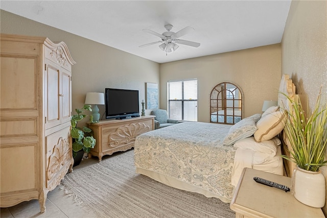 bedroom with ceiling fan and light tile patterned flooring