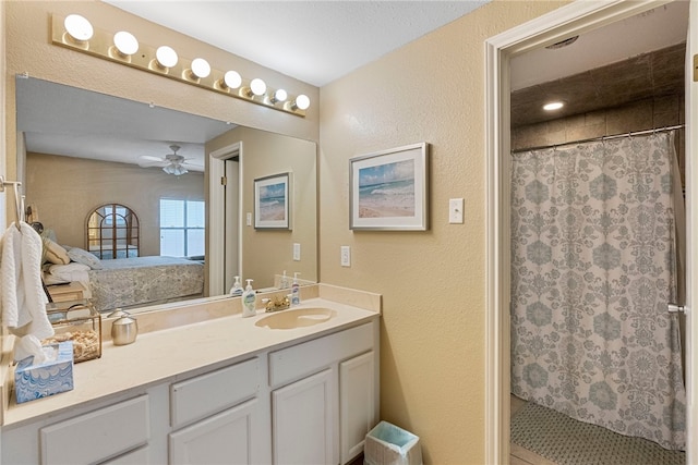 bathroom with vanity, ceiling fan, and a shower with curtain