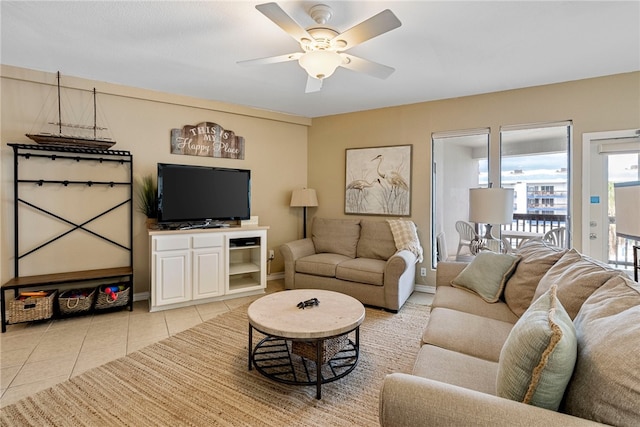 living room featuring light tile patterned floors and ceiling fan