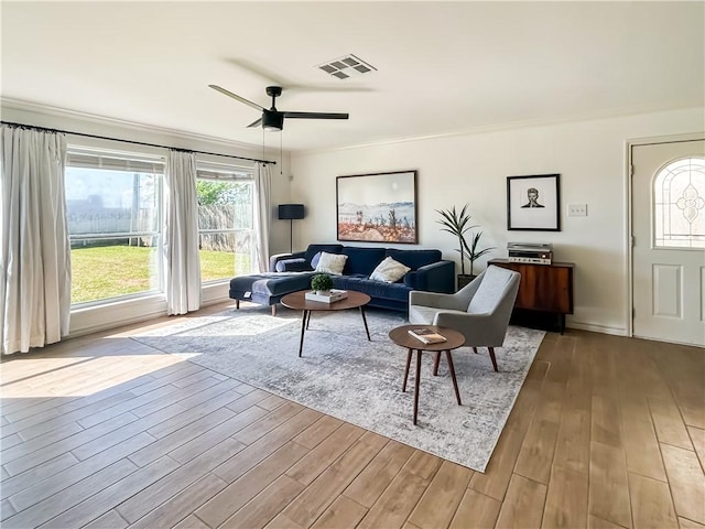 2418 Mystic Star Dr, Corpus Christi, TX 78414 - living room with wood finished floors, crown molding, a ceiling fan, and baseboards