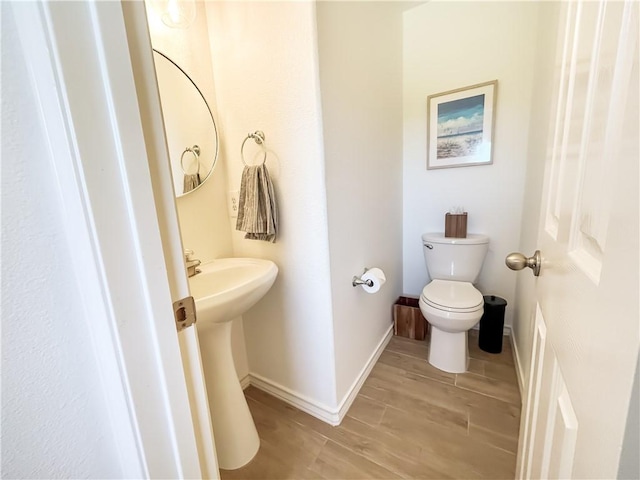 2418 Mystic Star Dr, Corpus Christi, TX 78414 - half bath featuring toilet, wood finished floors, and baseboards