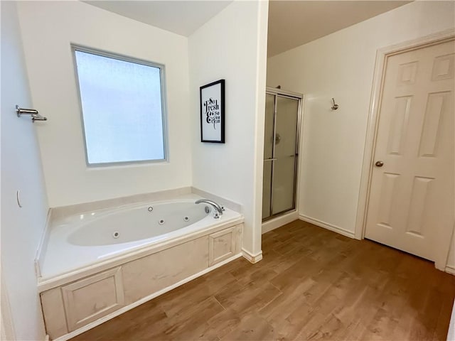 2418 Mystic Star Dr, Corpus Christi, TX 78414 - bathroom featuring healthy amount of natural light, a shower stall, a whirlpool tub, and wood finished floors