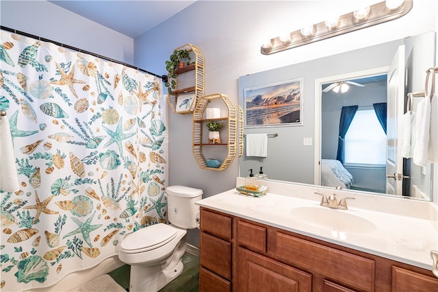 bathroom with toilet, ceiling fan, vanity, and curtained shower