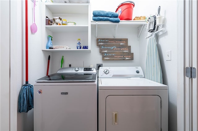 clothes washing area featuring independent washer and dryer