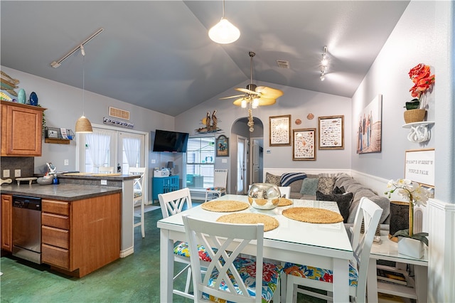 dining area featuring lofted ceiling, dark colored carpet, ceiling fan, and rail lighting