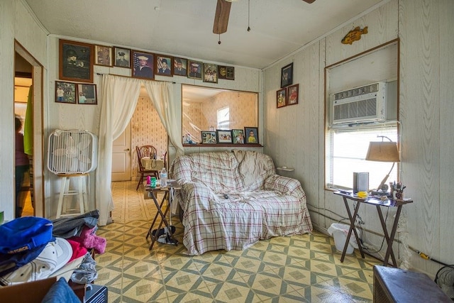 living area featuring ceiling fan, crown molding, and a wall mounted AC