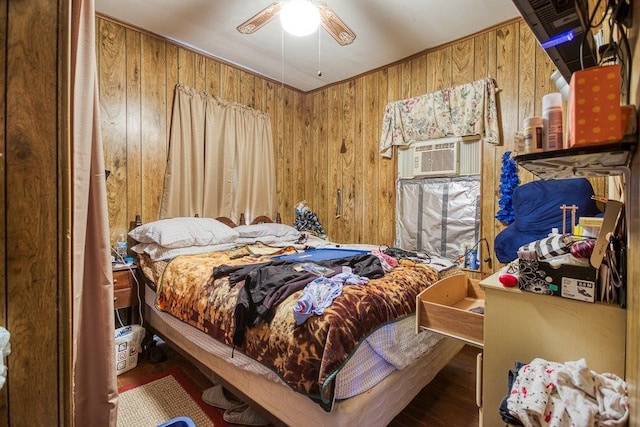 bedroom featuring ceiling fan and wood walls