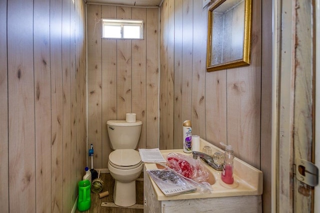 bathroom with toilet and wooden walls