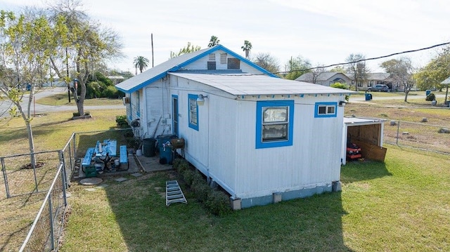 view of outdoor structure featuring a lawn