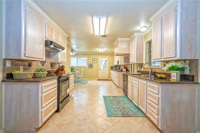 kitchen featuring black electric range, light tile patterned floors, ceiling fan, under cabinet range hood, and dishwashing machine