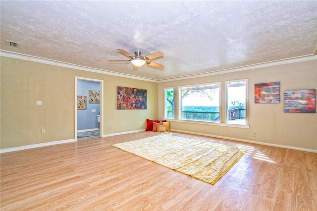 interior space featuring ornamental molding, wood finished floors, a textured ceiling, and ceiling fan