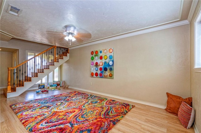interior space featuring visible vents, baseboards, wood finished floors, and ceiling fan
