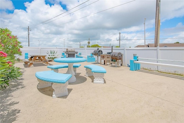 view of patio / terrace with outdoor dining area, a fenced backyard, and area for grilling