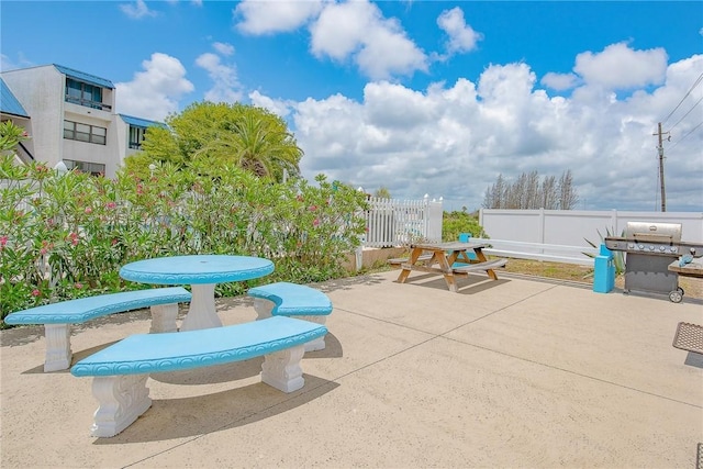 view of patio featuring area for grilling and fence