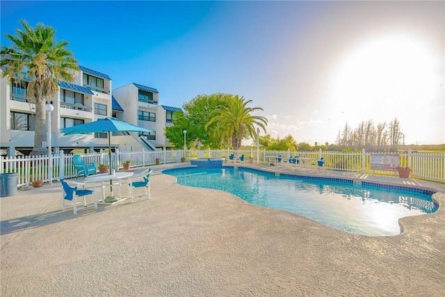 pool featuring a patio area and fence