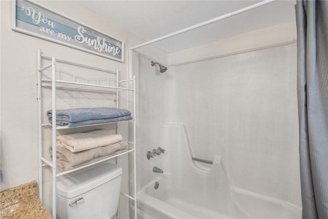 bathroom featuring shower / bath combo and toilet