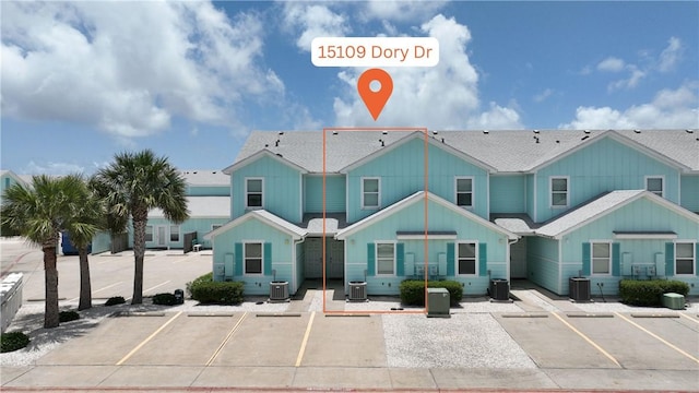 15109 Dory Dr, Corpus Christi, TX 78418 - view of front facade with uncovered parking, board and batten siding, and central air condition unit