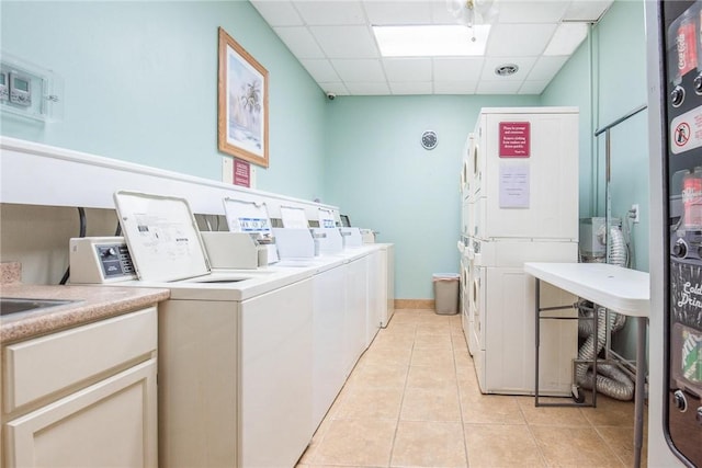 laundry room with light tile patterned floors and washing machine and clothes dryer