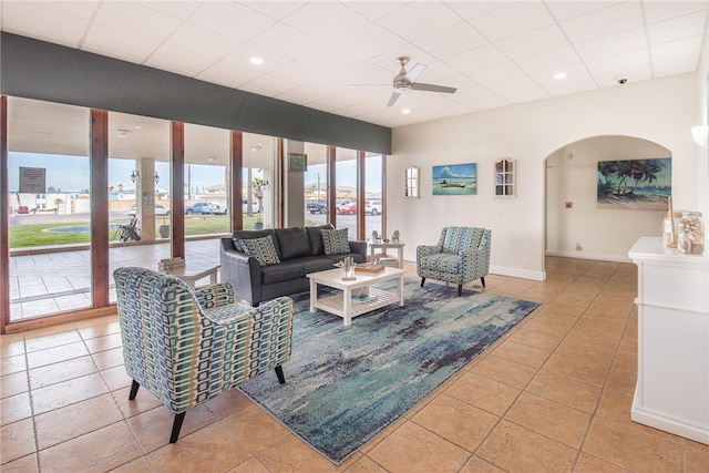 tiled living room with ceiling fan