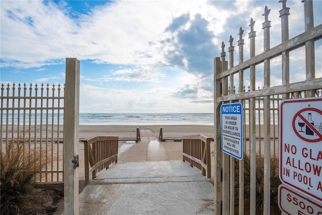 surrounding community featuring a water view and a view of the beach