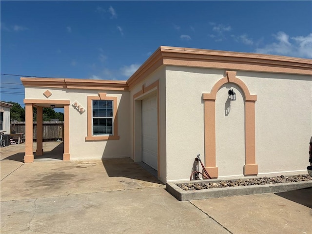 915 Flour Bluff Dr, Corpus Christi, TX 78418 - doorway to property with a garage, stucco siding, and driveway