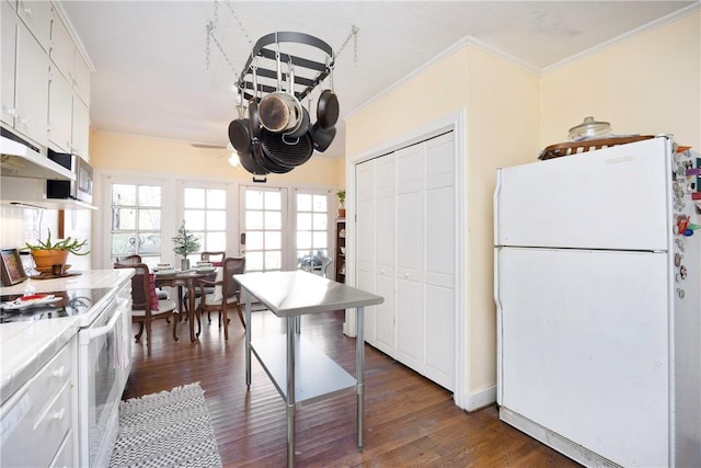 kitchen with dark hardwood / wood-style flooring, white appliances, ceiling fan, white cabinetry, and tile counters