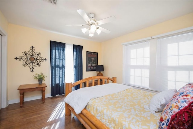 bedroom featuring ceiling fan and dark hardwood / wood-style flooring