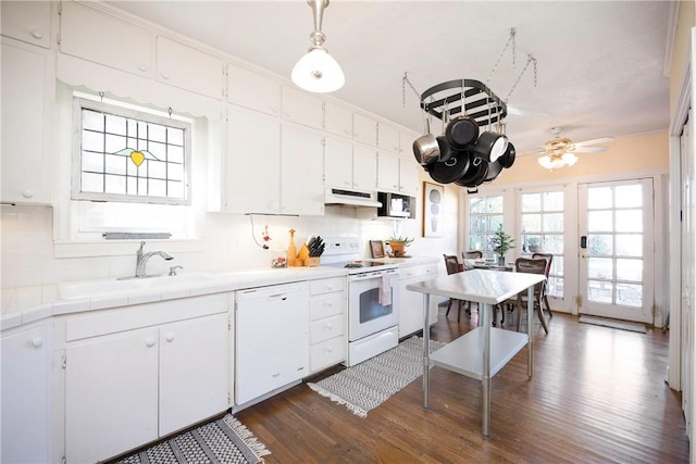 kitchen featuring white cabinetry, dark wood-type flooring, and white appliances