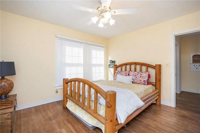 bedroom with ceiling fan and dark wood-type flooring