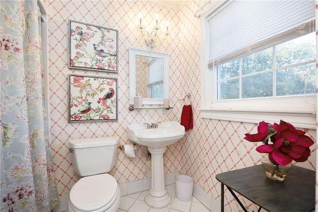 bathroom with tile patterned flooring and toilet