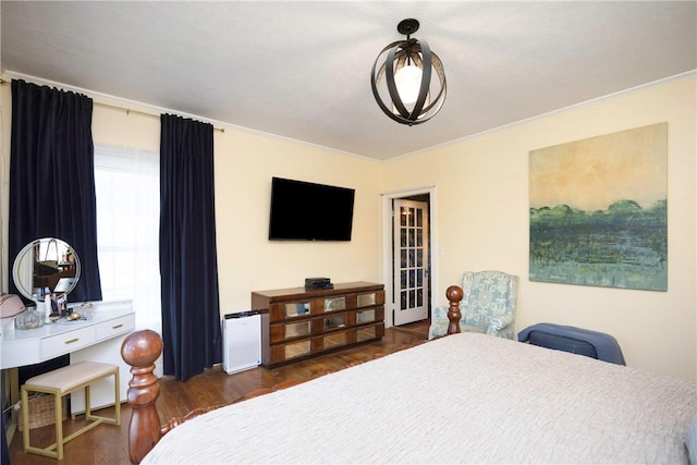 bedroom with crown molding and dark wood-type flooring