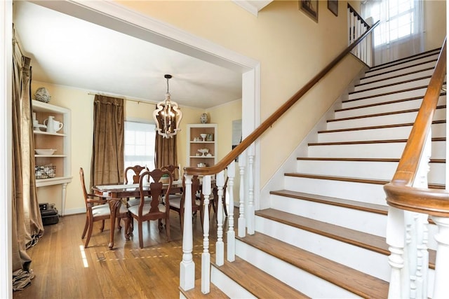 dining area with hardwood / wood-style flooring and an inviting chandelier