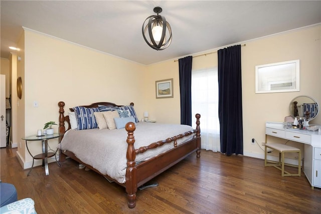 bedroom with dark hardwood / wood-style flooring and ornamental molding