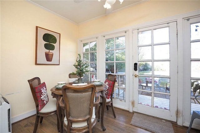 dining space featuring hardwood / wood-style floors and crown molding