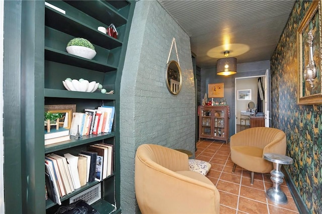 living area with tile patterned floors